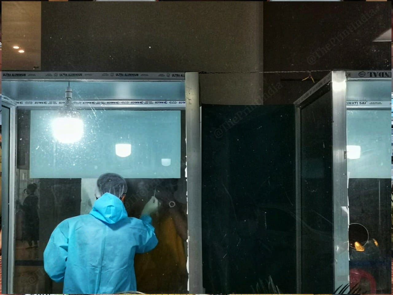 Lab technicians collect swabs from passengers at the zonal screening centre setup at Kiranshree Grand Hotel near the Guwahati airport. | Photo: Angana Chakrabarti | ThePrint