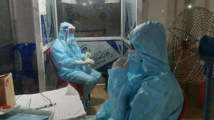 Here lab technicians in the screening centre at the Kiranshree Grand Hotel take a breather. The centre has been screening about 500 passengers daily.| Photo: Angana Chakrabarti | ThePrint