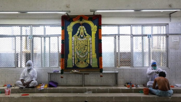 Barbers in PPE overalls wait for devotees who wish to offer their hair to the deity. Shaving one’s head at the temple is a common practice | Manisha Mondal | ThePrint