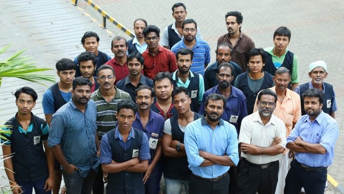 Mezhukkattil Mill executive director Ubais Ali (third from right in thr front row) with his employees | By special arrangement