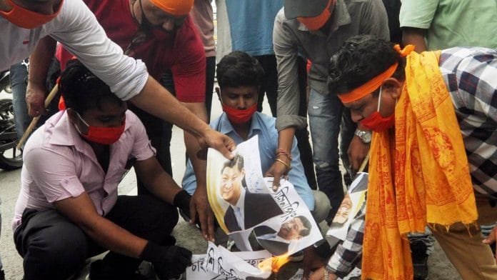 Members of VHP youth wing Bajrang Dal burn photographs of Chinese President Xi Jinping in Guwahati | Photo: ANI