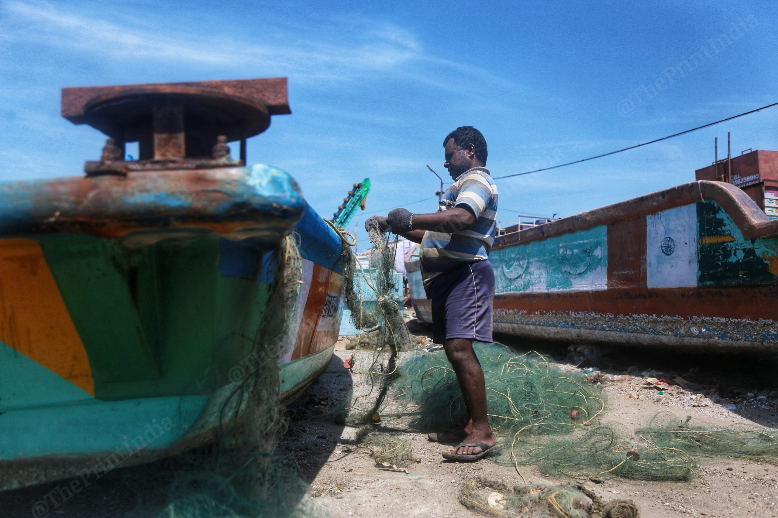 A fisherman sorts out his nets | Manisha Mondal | ThePrint
