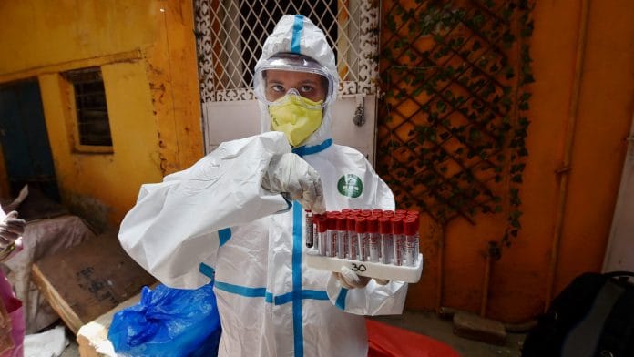 A medic collects samples during door-to-door serological survey to analyse the spread of COVID-19, at Paharganj in New Delhi | PTI