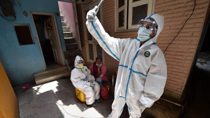 A medic clicks a selfie after collecting blood samples for serological survey to analyse the spread of COVID-19, at Paharganj in New Delhi | PTI