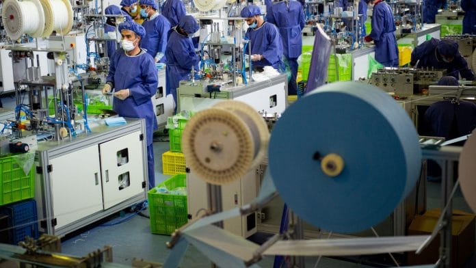 Rolls of material used in the manufacture of protective face masks sit near machines at the opening of a new factory near Tehran, Iran on 14 April