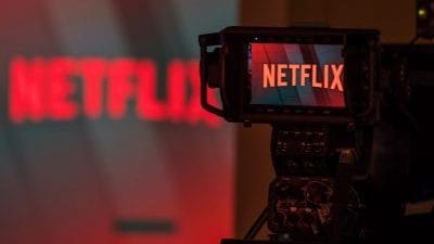 A television camera focuses on the Netflix logo | Photo: Chris Ratcliffe | Bloomberg