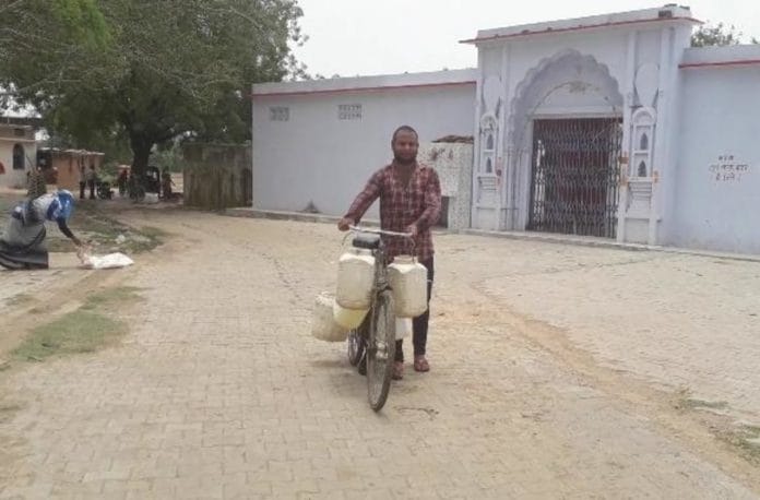 A man carrying water on his bicycle in a Jhansi village. | Photo: Prashant Srivastava/ThePrint