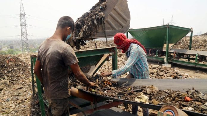 The workers at the landfill separate the wood, stones from the waste | Photo: Suraj Singh Bisht | ThePrint