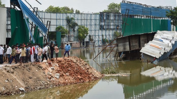 Locals look on at the site of a building collapse, due to monsoon rain, at Anna Nagar in New Delhi, Monday, 20 July, 2020. | Shahbaz Khan/PTI