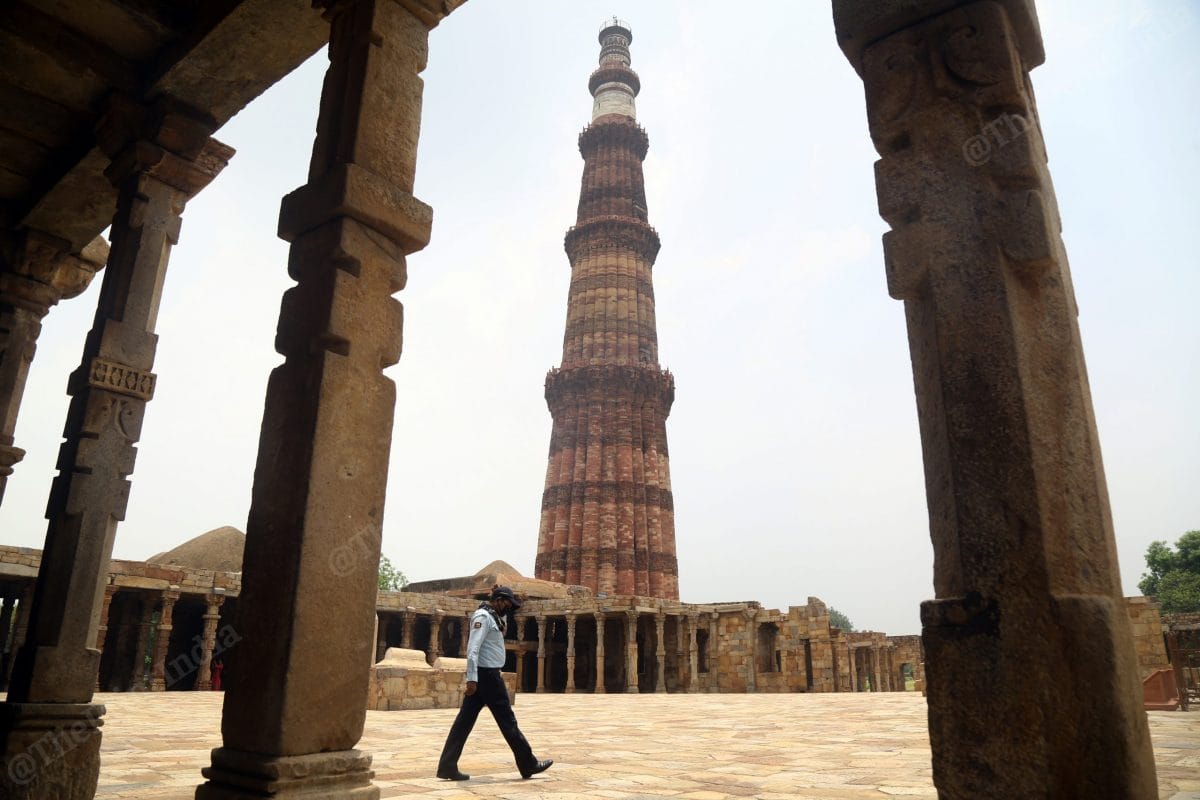 A security person walk past the Qutub Minar | Photo: Suraj Singh Bisht | ThePrint