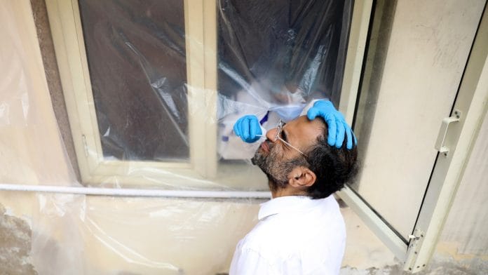 A health worker collects a sample using a swab from a man at a health centre to conduct tests for the COVID-19 in Delhi (representational image) | ANI