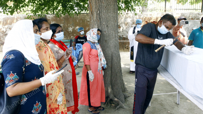 Shaji John's family at his funeral Saturday at the Alpha Omega Christian Welfare Cemetery in Mongolpuri | Photo: Praveen Jain | ThePrint