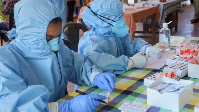 Health workers prepare to collect swab samples for COVID-19 tests, at an office in Kozhikode on 21 July 2020 | PTI
