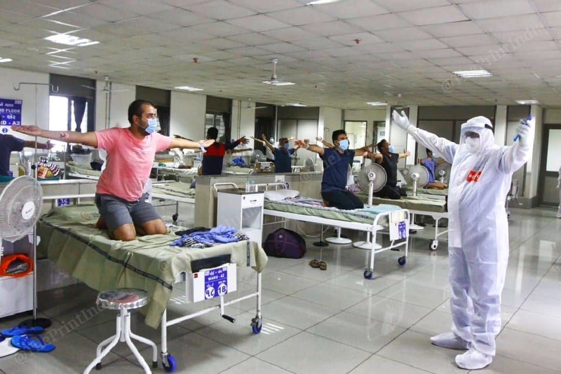 A doctor encourages a recovering Covid-19 patient to do a yoga aasan | Photo: Praveen Jain | ThePrint