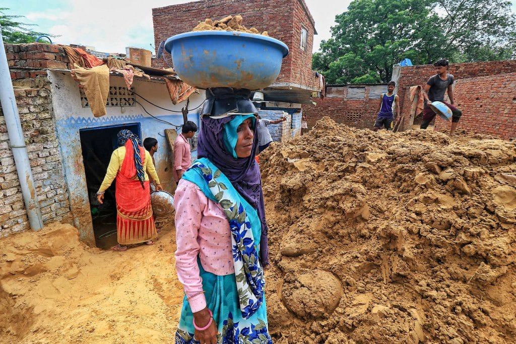 Workers clear landslide debris after heavy rainfall, at Lal Dungri area in Jaipur, 21 Aug | PTI