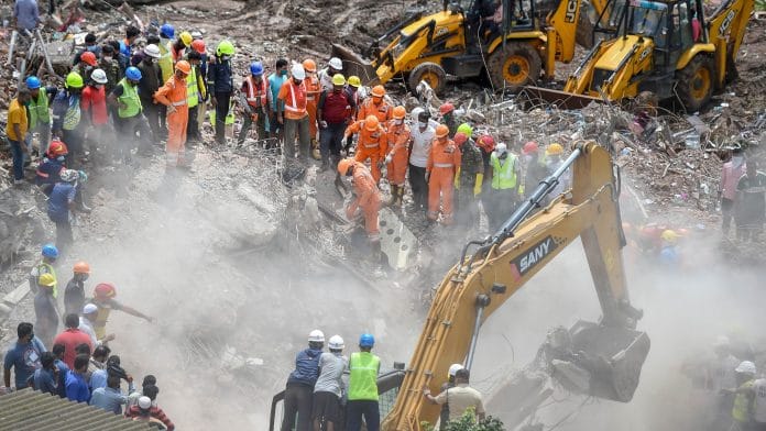 Rescue personnel sift through the rubble in search of survivors at the site where a five-storey apartment building collapsed, at Mahad in Raigad district | Kunal Patil | PTI