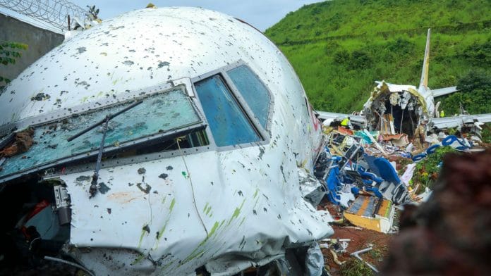 Officials inspect the wreckage of an Air India Express jet at Calicut International Airport in Karipur, Kerala | Photographer: Arunchandra Bose | AFP/Getty Images via Bloomberg