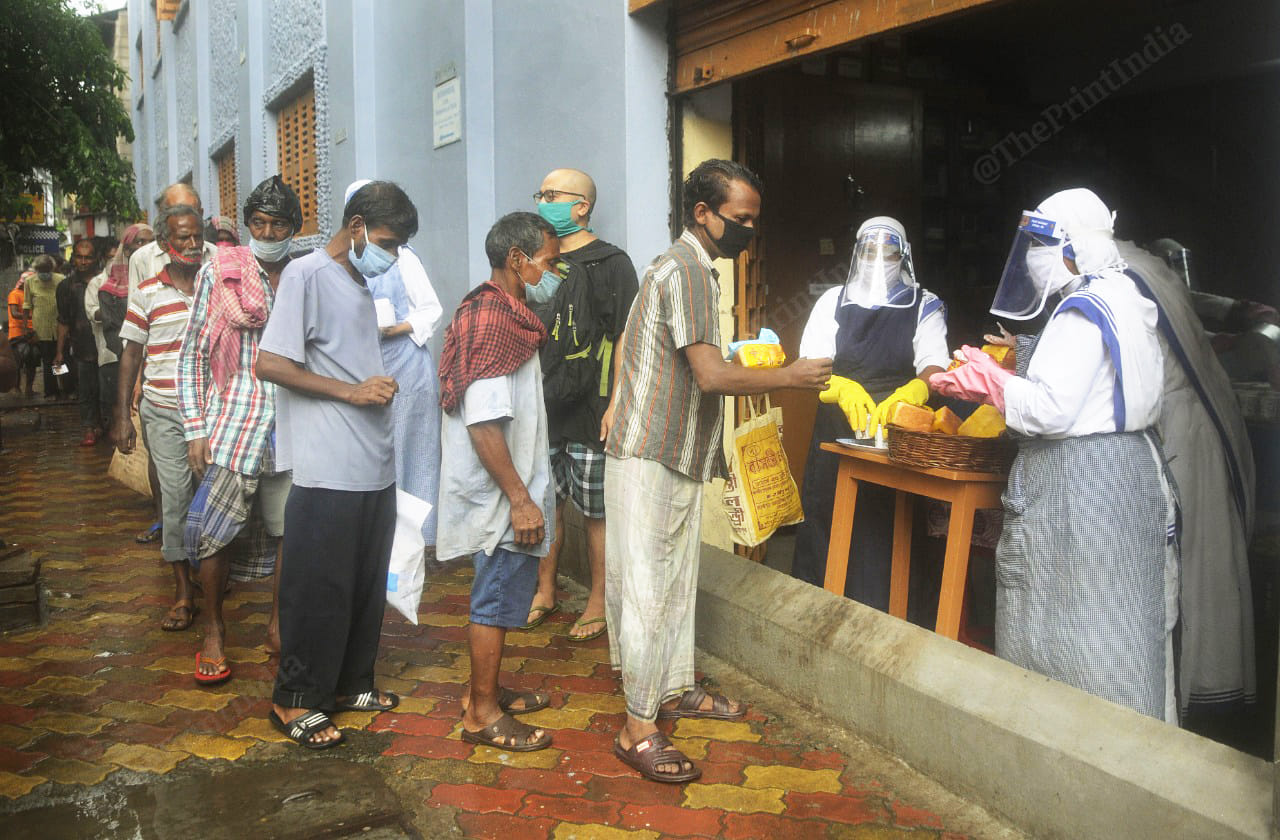 People stand in queue to collect food | Photo: Ashok Nath Dey | ThePrint