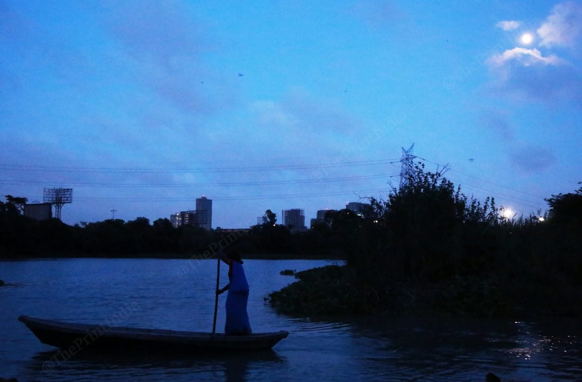 A woman uses the boat to go to the nearest shop to buy groceries | Photo: Manisha Mondal | ThePrint