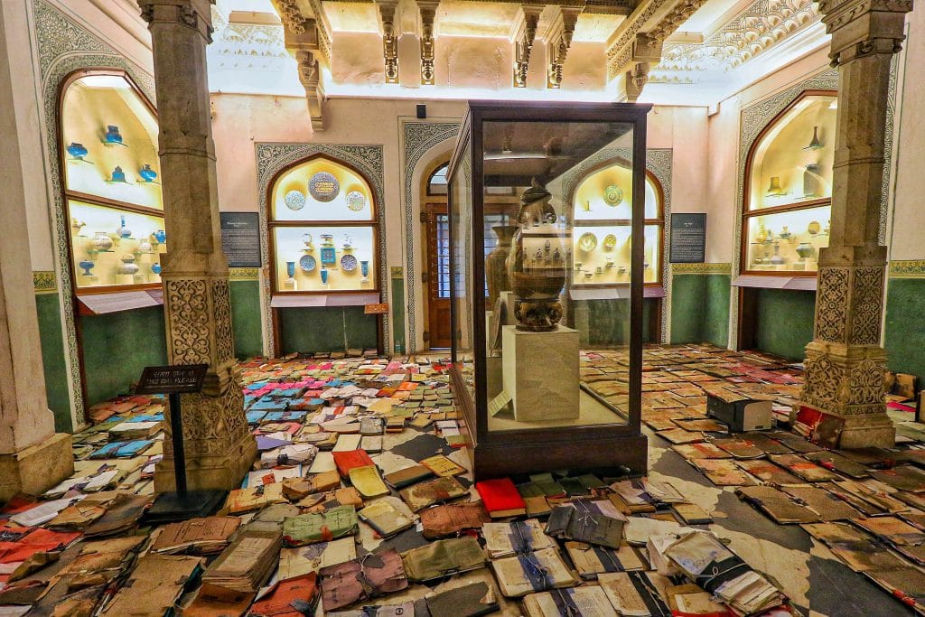 Documents of records kept for drying on a floor after rain water entered the historic Albert Hall museum, in Jaipur, 18 Aug | PTI