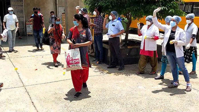 Representational image of recovered Covid-19 patients being showered with petals on leaving a hospital in Madhya Pradesh | Photo: ANI