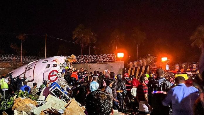 Rescue operation underway after an Air India Express flight with passengers on board en route from Dubai skidded off the runway while landing, at Karippur in Kozhikode | PTI