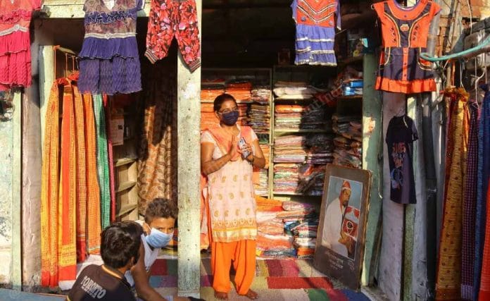 Seema Gupta’s father Vasudev Gupta was among the kar sevaks killed in UP Police firing in 1990. Here, his photo is seen at his daughter's garment shop | Suraj Singh Bisht | ThePrint