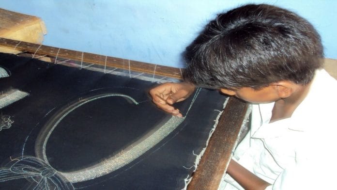 A child works on a jewelry piece. | Bloomberg