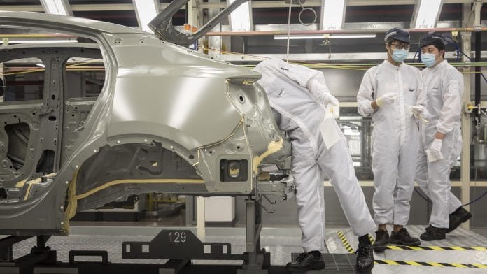 Employees work in a paint shop at the Geely Automobile Holdings Ltd. plant in Ningbo, Zhejiang Province, China, on April 28