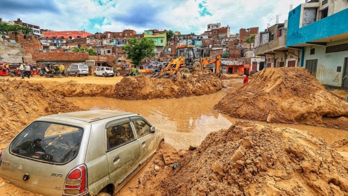 File photo | A vehicle lies buried in landslide debris following heavy rainfall, in Jaipur | PTI