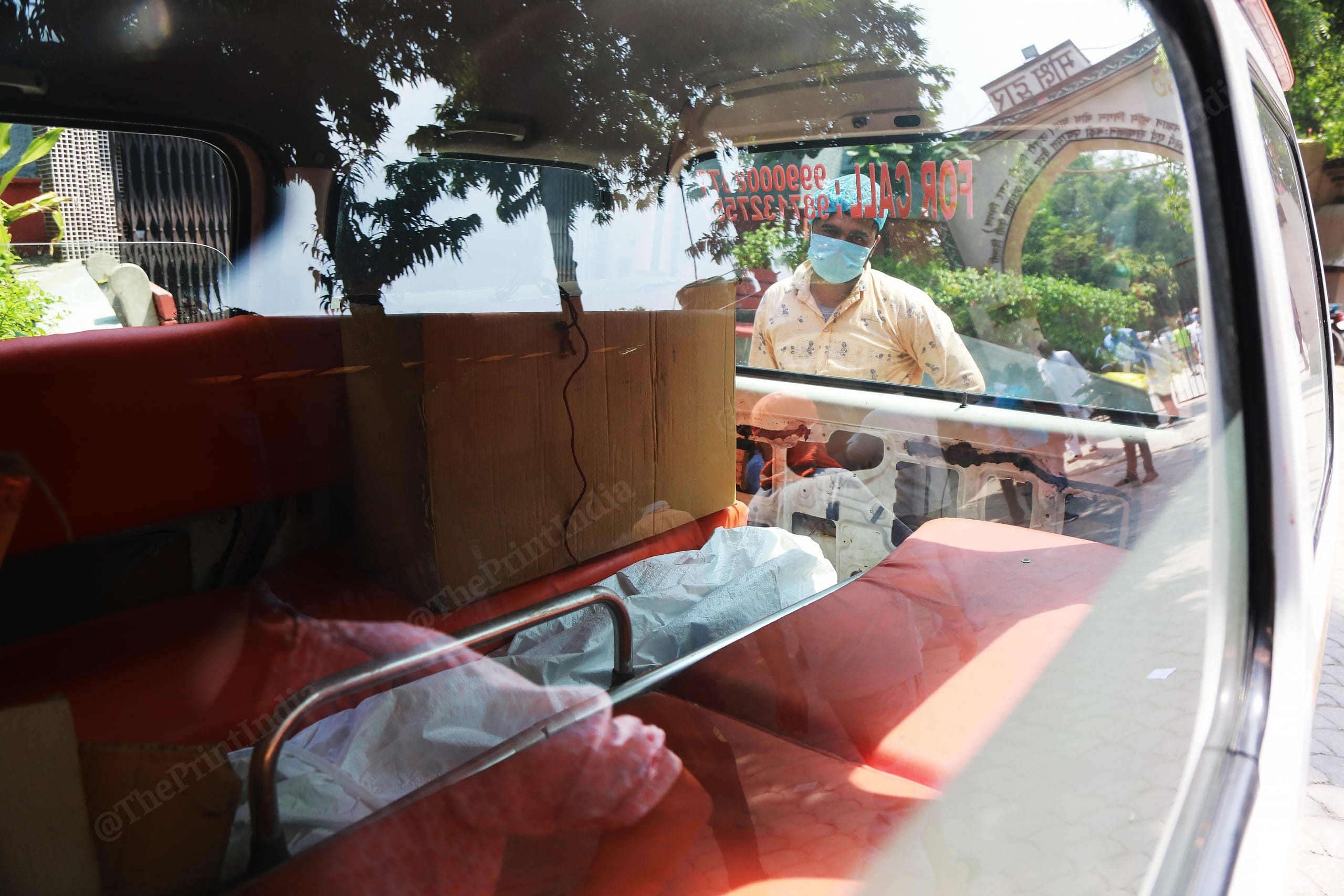 Ansar looks inside the ambulance if the bodies have been taken out. | Photo: Manisha Mondal/ThePrint