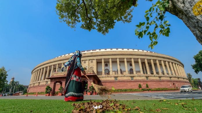A civic worker sweeps a lawn in the premises of Parliament House during the ongoing Monsoon Session, in New Delhi, Tuesday, 15 September 2020 |PTI /Kamal Kishore