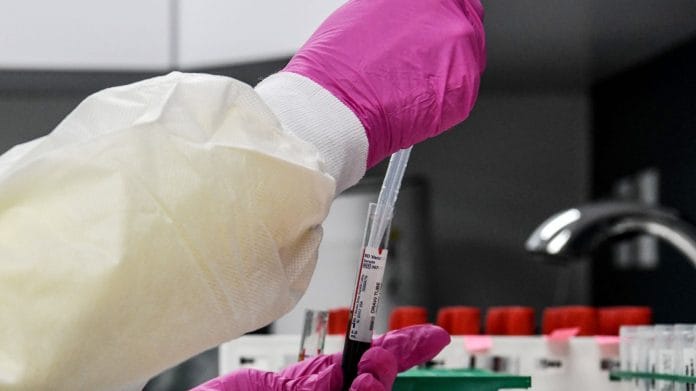 A lab technician sorts blood samples for COVID-19 vaccination study at the Research Centers of America in Hollywood, Florida. | Photographer: Chandan Khanna | AFP/Getty Images via Bloomberg