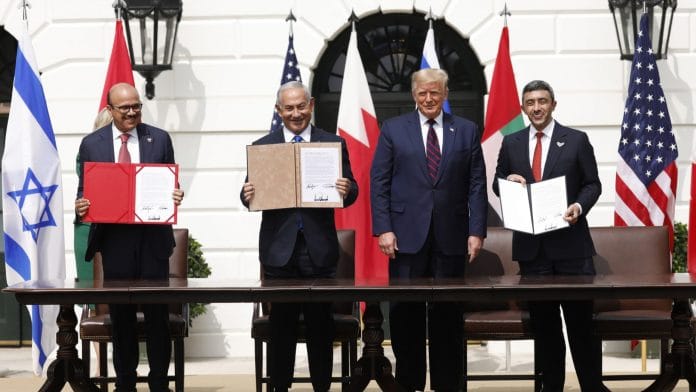 Abdullatif bin Rashid Al Zayani, Benjamin Netanyahu and Sheikh Abdullah bin Zayed bin Sultan Al Nahyan hold signed documents during an Abraham Accords signing ceremony event with Donald Trump | Photographer: Yuri Gripas/Abaca/Bloomberg