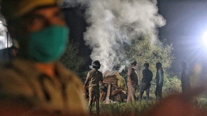 File photo of the Uttar Pradesh Police cremating the Hathras gangrape and murder victim in the middle of the night | Manisha Mondal | ThePrint