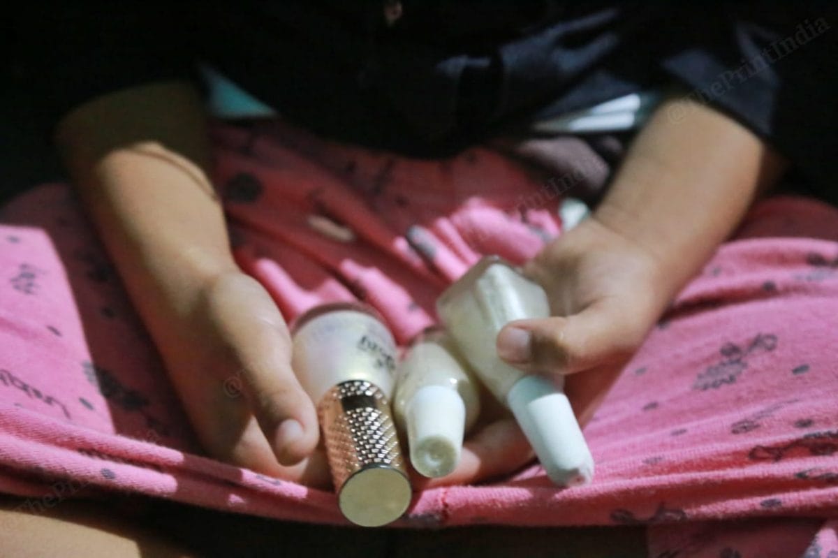 Niece of the 20-year-old plays with the bottles of nail polishes that she loved. She never wore dark colours said her sister in law | Photo: Manisha Mondal| ThePrint