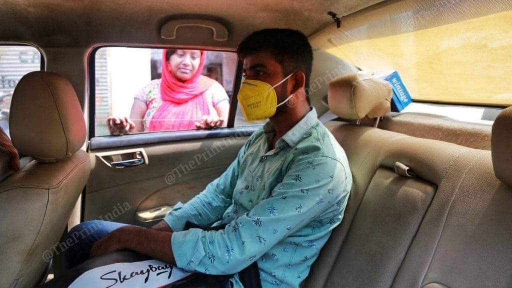 Mother Rukma Devi sees off Vineet in the car they've hired to take him to his exam centre in Rohini | Photo: Manisha Mondal | ThePrint