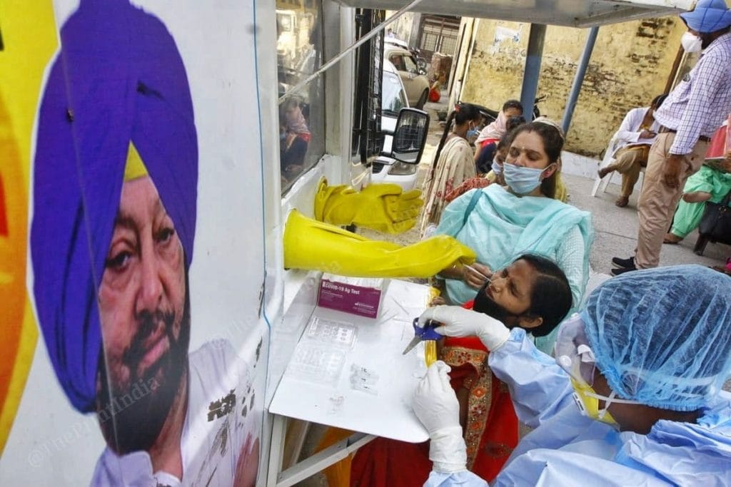 Villagers get tested for Covid in Sanhnewal village. The van has the photo of Punjab Cheif Minister Capt Amrinder Singh | Praveen Jain | ThePrint