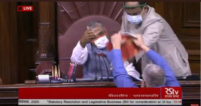 TMC MP Derek O'Brien shows the House rule book to Rajya Sabha deputy chairman Harivansh Sunday | Photo: ANI