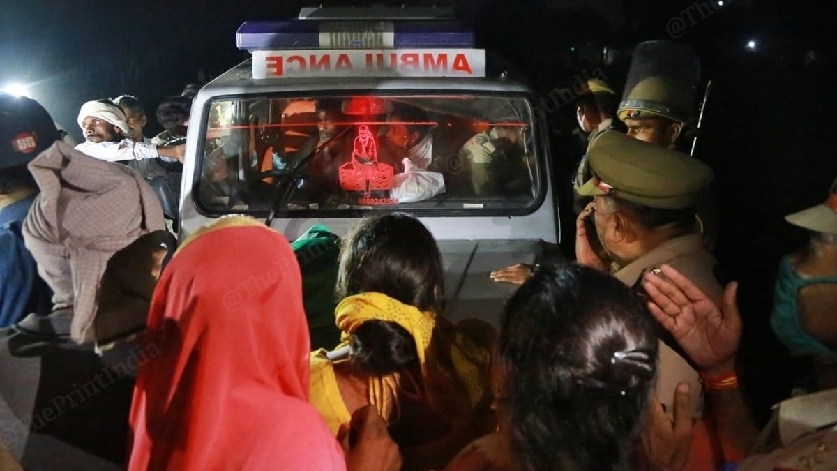 The family members of the Hathras 'gang-rape and assault' victim blocking the ambulance's path on 30 September in Bool Garhi village. | Photo: Manisha Mondal/ThePrint