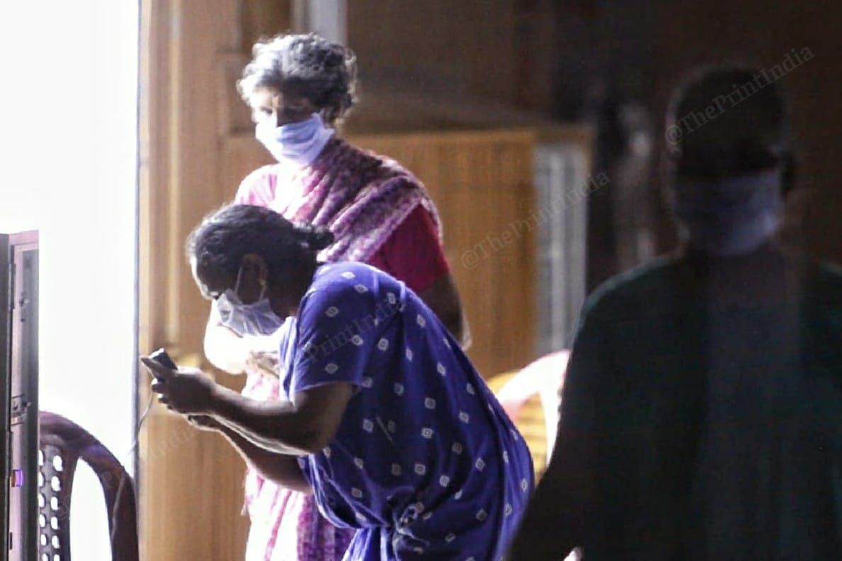 A lady charges her phone | Photo: Praveen Jain | ThePrint