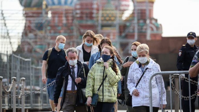 Tourists wear protective face masks on Red Square in Moscow, Russia | Bloomberg