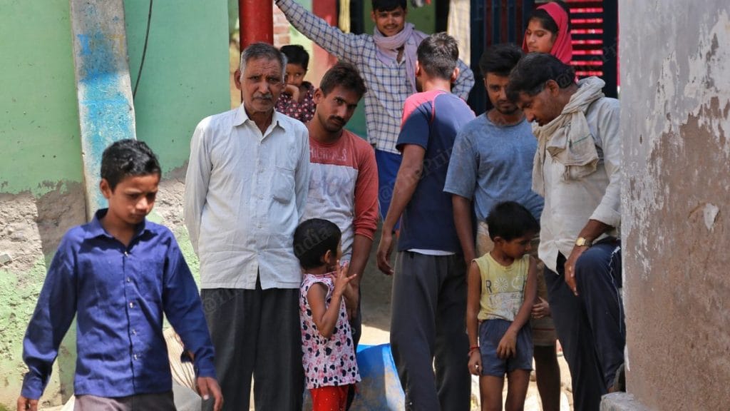 Accused Luvkush Thakur's father, a chowkidar, surrounded by members of his extended family | Photo: Manisha Mondal | ThePrint