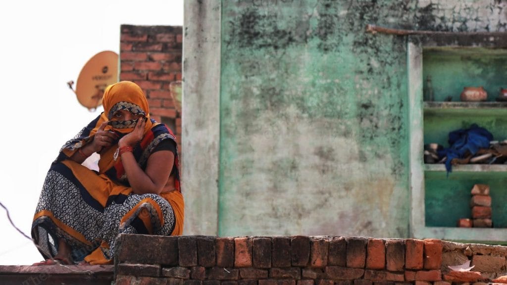 A relative of Hathras gang-rape and murder accused Sandeep Thakur sits on the terrace of her house in Boolgarhi village, Hathras | Photo: Manisha Mondal | ThePrint