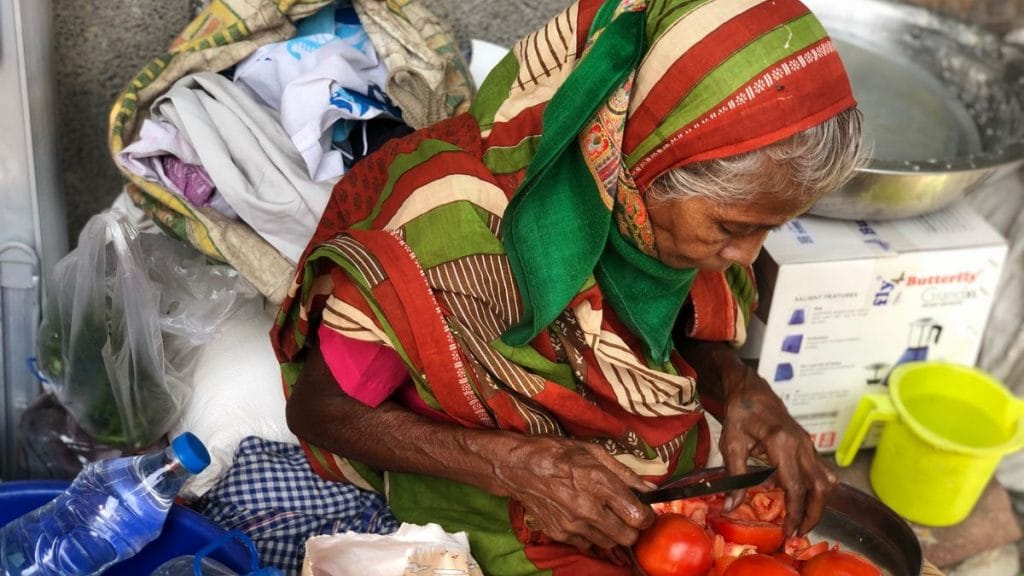 Badami Devi sits outside Baba ka Dhaba and chops tomatoes | Photo: Jyoti Yadav | ThePrint