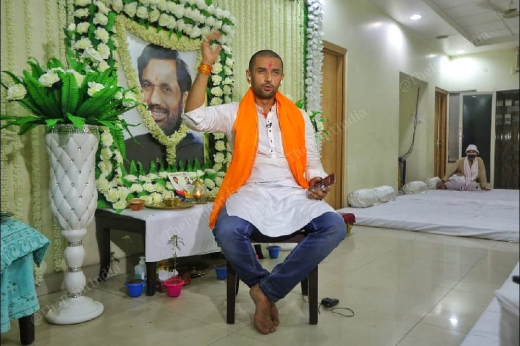 LJP president Chirag Paswan at his residence. A photo of his father Ram Vilas Paswan, who died earlier this month, is seen behind him | Praveen Jain | ThePrint