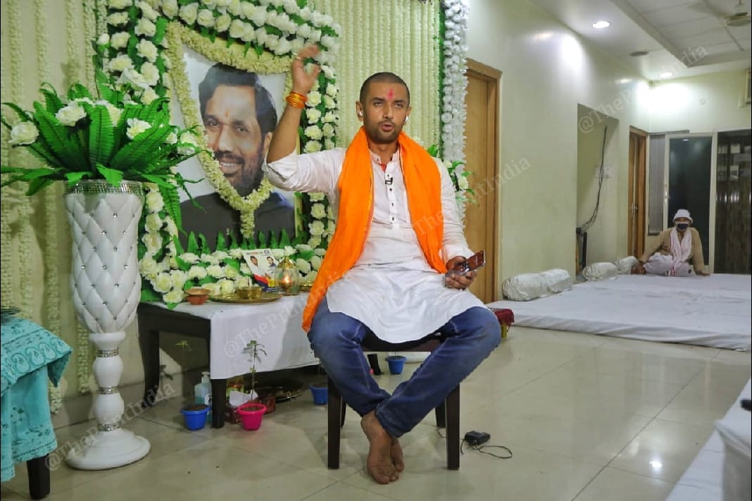 LJP president Chirag Paswan at his residence. A photo of his father Ram Vilas Paswan, who died earlier this month, is seen behind him | Praveen Jain | ThePrint