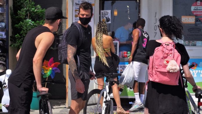 People walk on the board walk in Venice Beach in California wearing masks (representational image) | Flickr