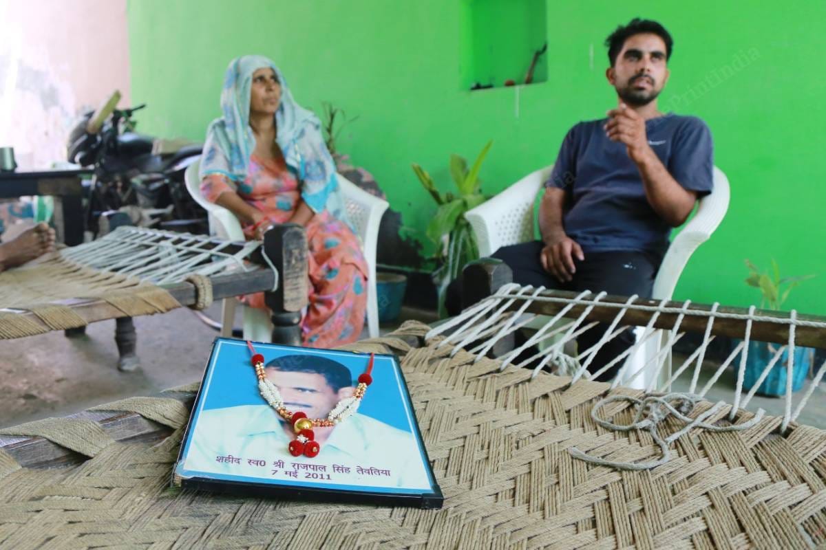 Deepak Tewatia with a photo of his father Rajpal Tewatia | Manisha Mondal | ThePrint