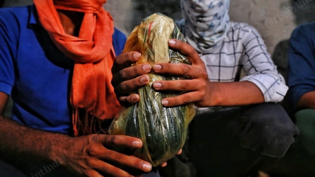 Hathras victim's family holding her ashes. | Photo: Manisha Mondal/ThePrint